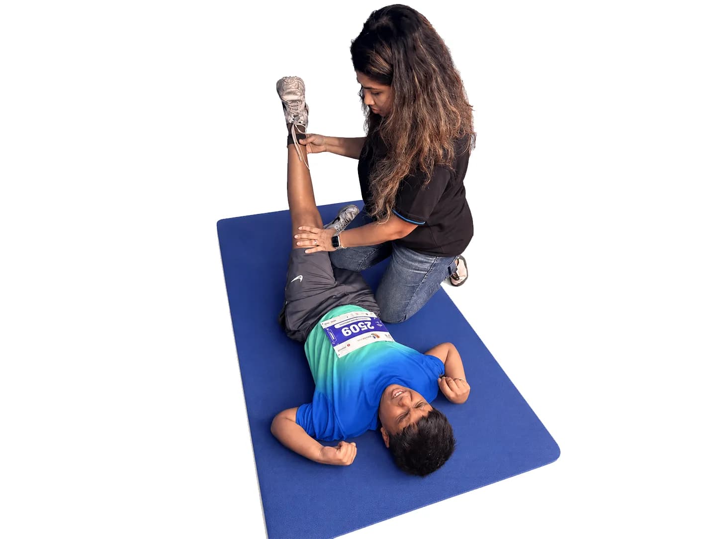 A podiatrist performing manual therapy, stretching a patient's leg during a session